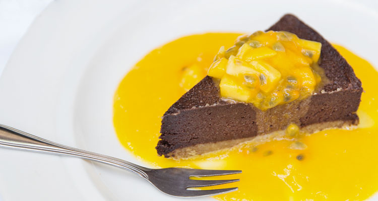 Delicious raw chocolate cake with mango and passionfruit ends another delicious meal at your yoga retreat in Ubud.