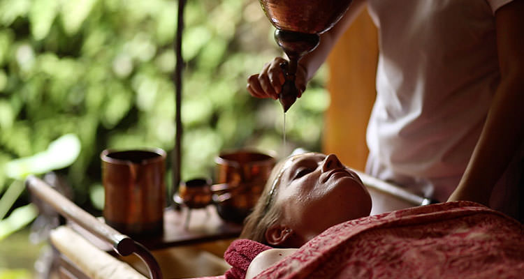 Blissful Ayurvedic shirodhara treatment performed in the spa of Ubud yoga retreat centre of Oneworld Retreats in Bali.