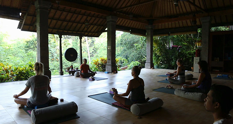 Restorative evening yoga session at Oneworld Retreats, provider of the best yoga retreats in Ubud, Bali.